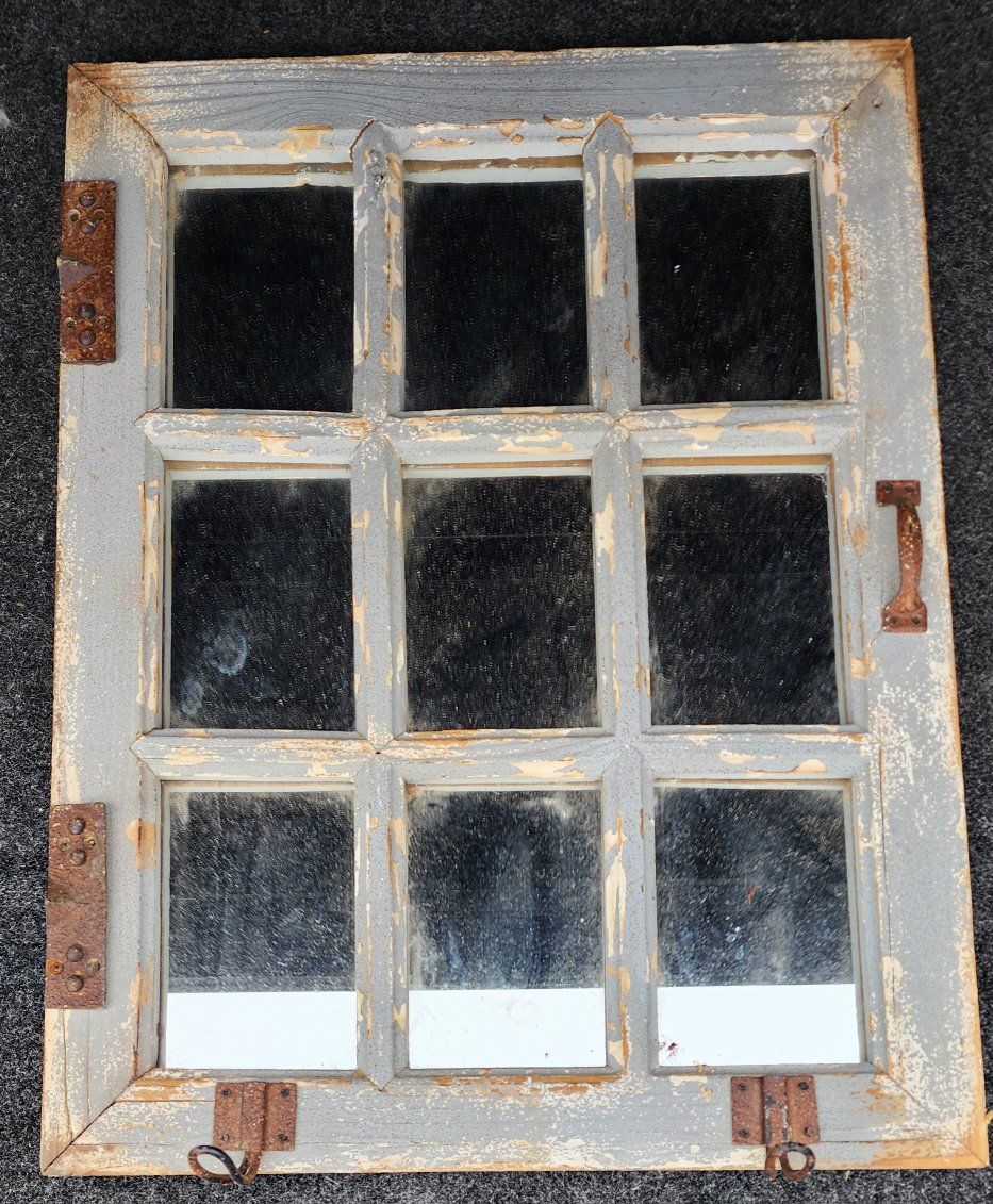 old window mirror with handles and hooks.