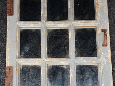 old window mirror with handles and hooks.