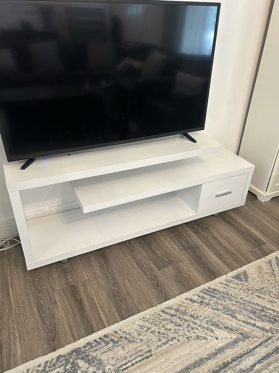Modern white entertainment stand with shelves and drawer