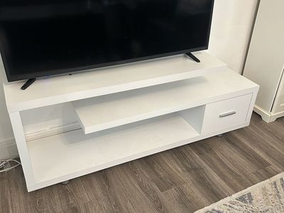 Modern white entertainment stand with shelves and drawer
