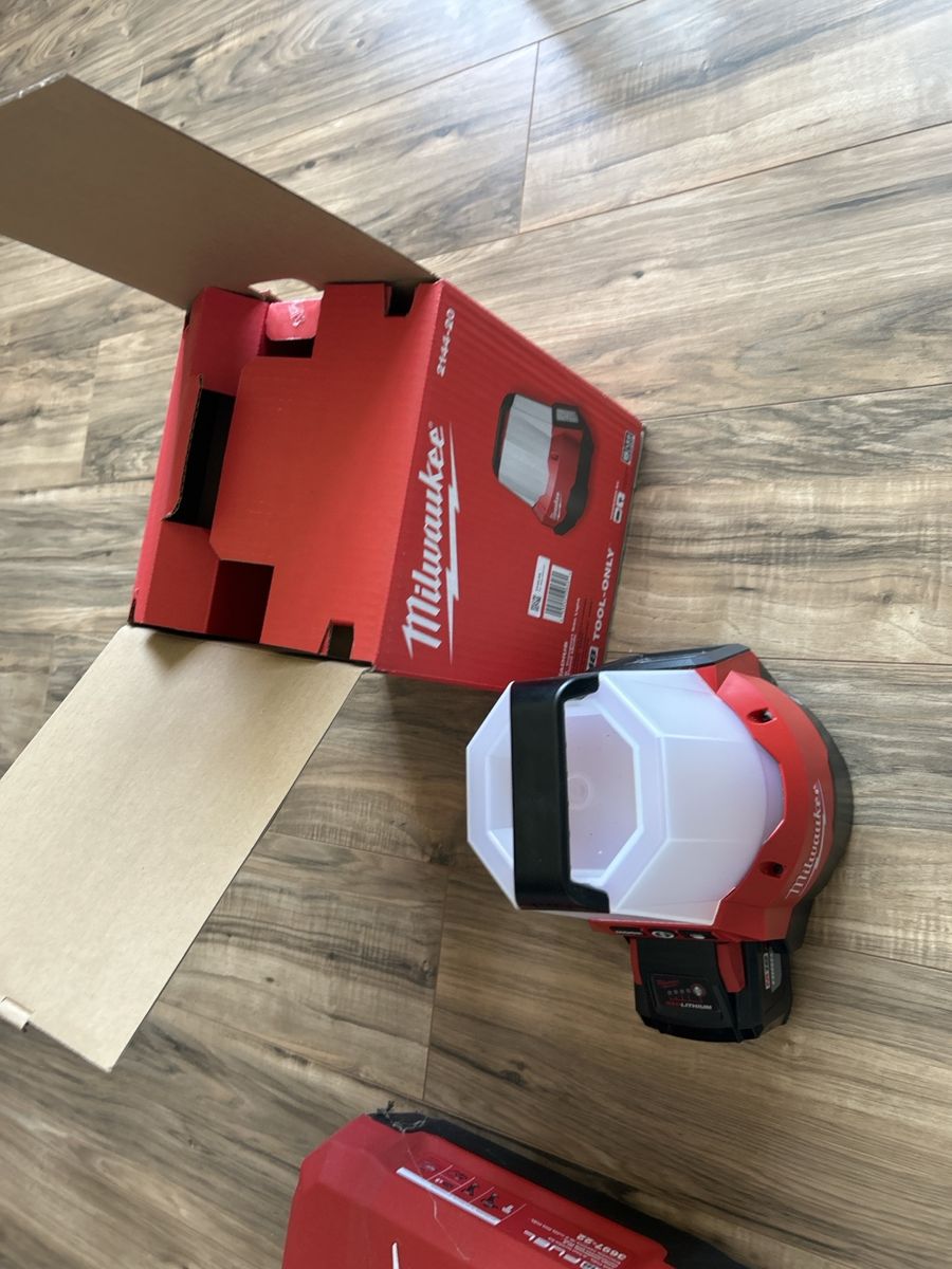 Milwaukee power tools, chargers, and light with hard case