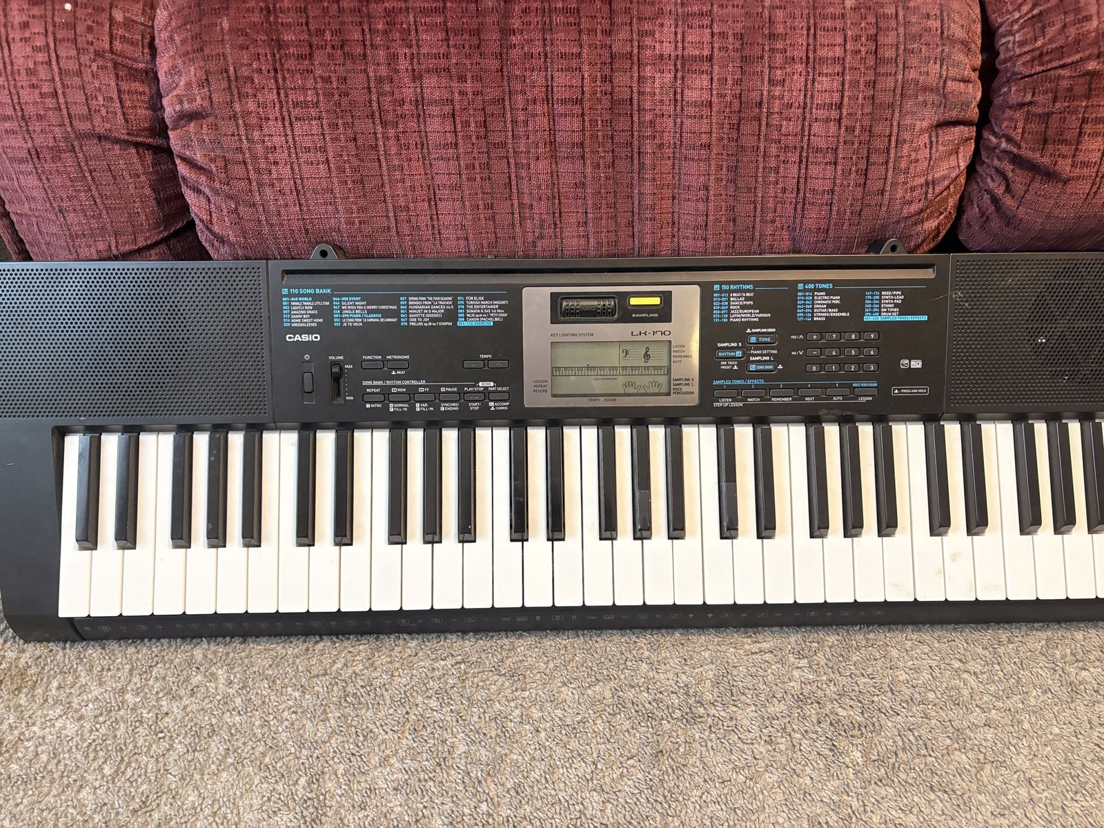 Black Casio LK-170 61-key portable keyboard featuring a key-lighting system and a central LCD contro