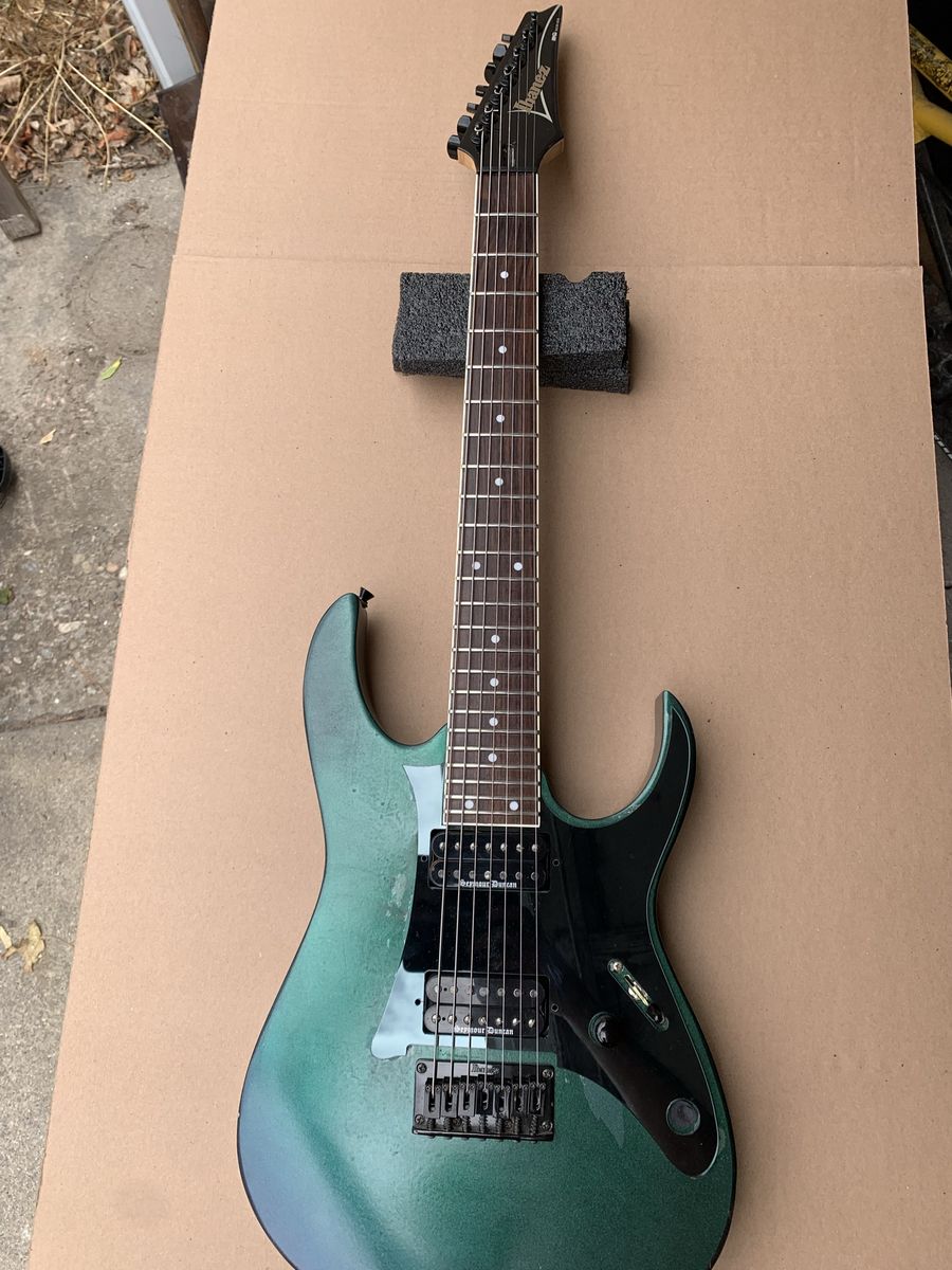 Ibanez RG7321 7-string.  Duncan Black Winters.  Rattle can paint job riff machine. 