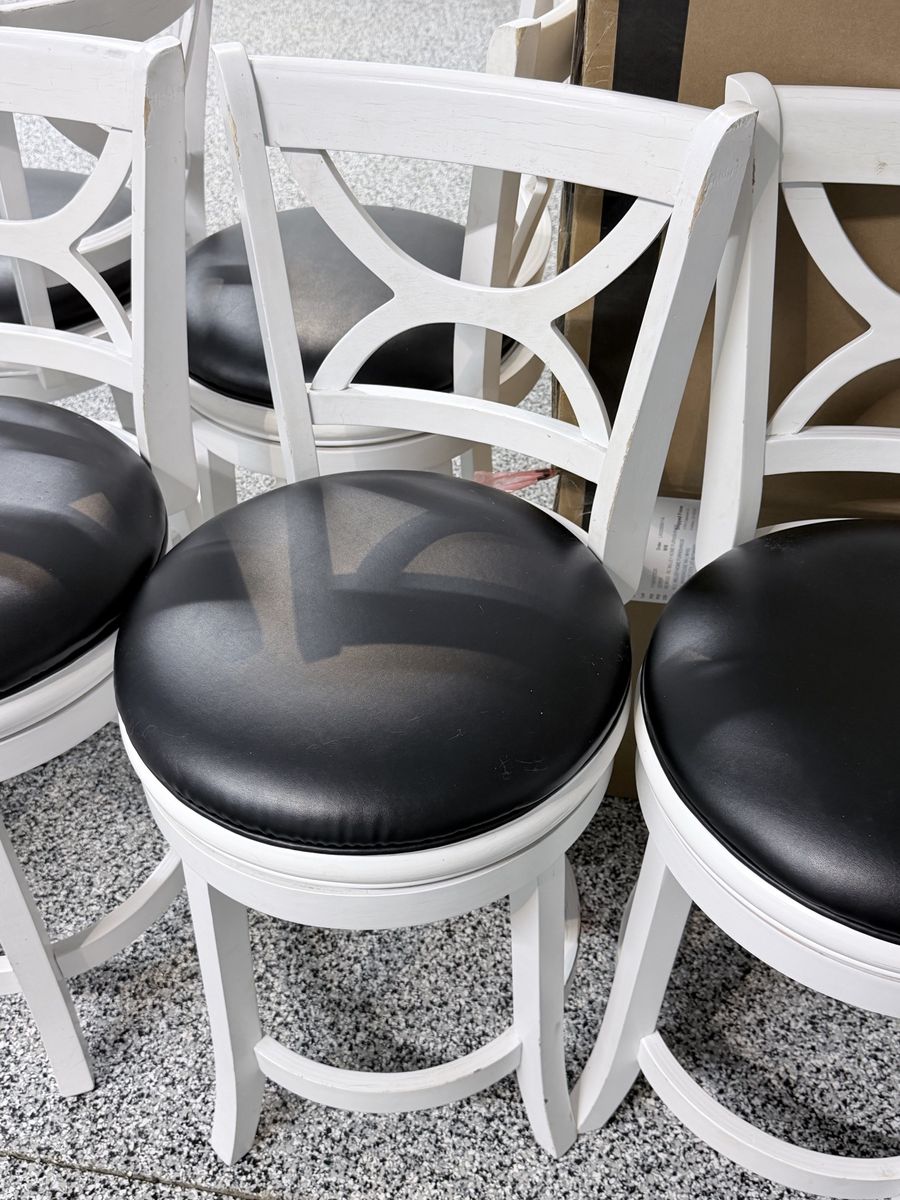 White wooden barstools with black cushion seats
