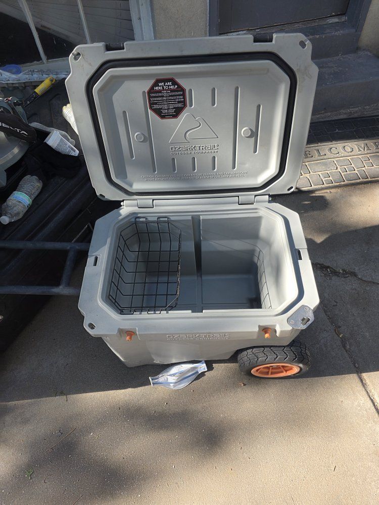 The Ozark Trail 45 Qt High Performance Hard Sided Rolling Cooler shown in the image typically ranges in value from $130 to $175