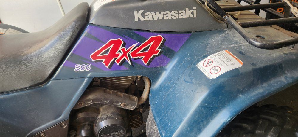 Kawasaki 4x4 300cc ATV with blade and lift