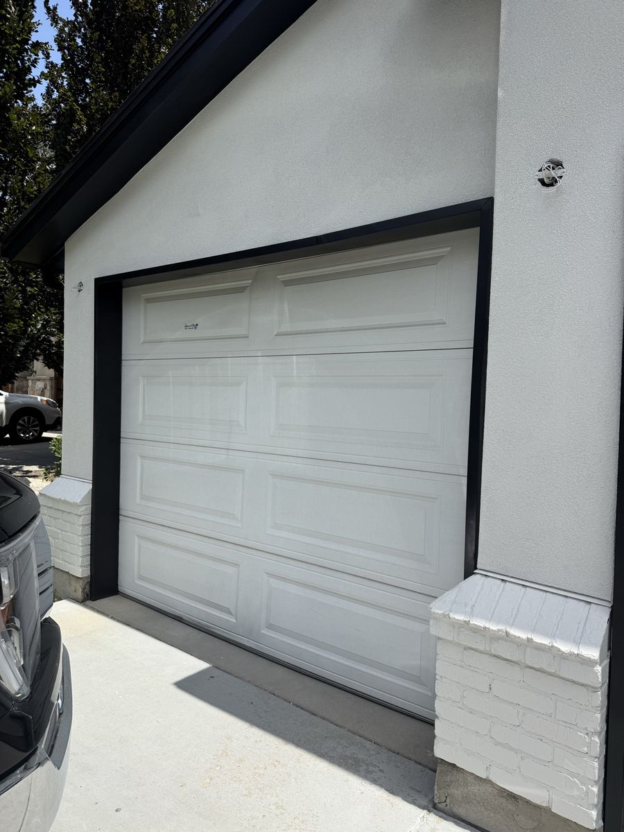 Two garage doors, spring assembly, and tracks