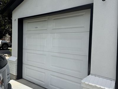 Two garage doors, spring assembly, and tracks