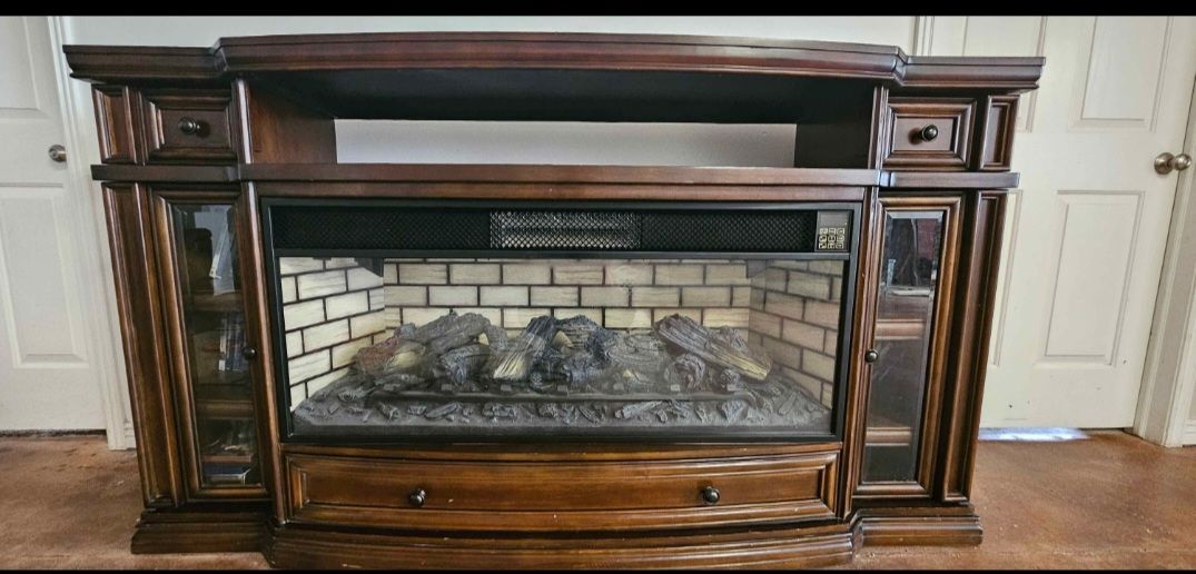 Entertainment stand with faux fireplace and space heater