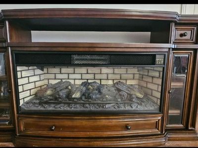 Entertainment stand with faux fireplace and space heater