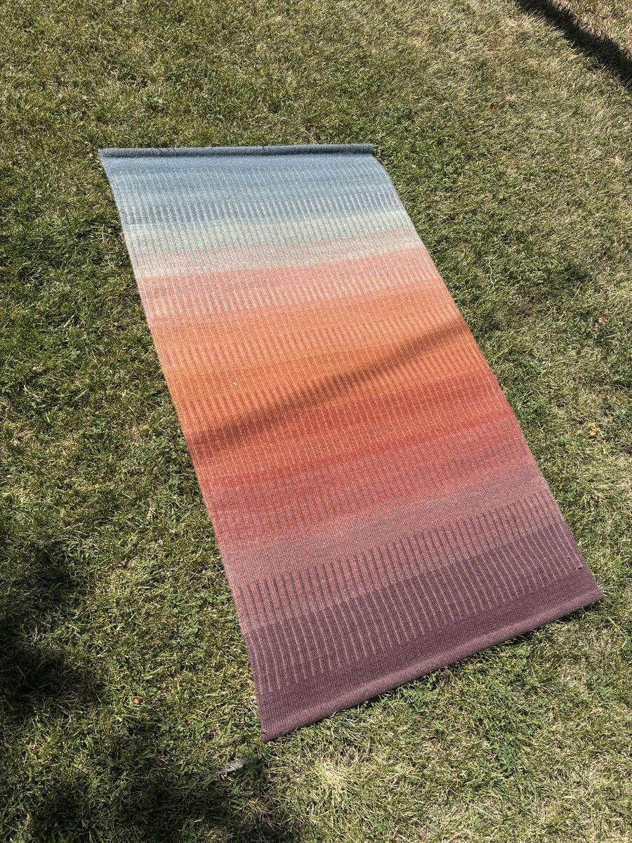 Ombré hand woven rug with label