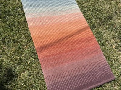 Ombré hand woven rug with label