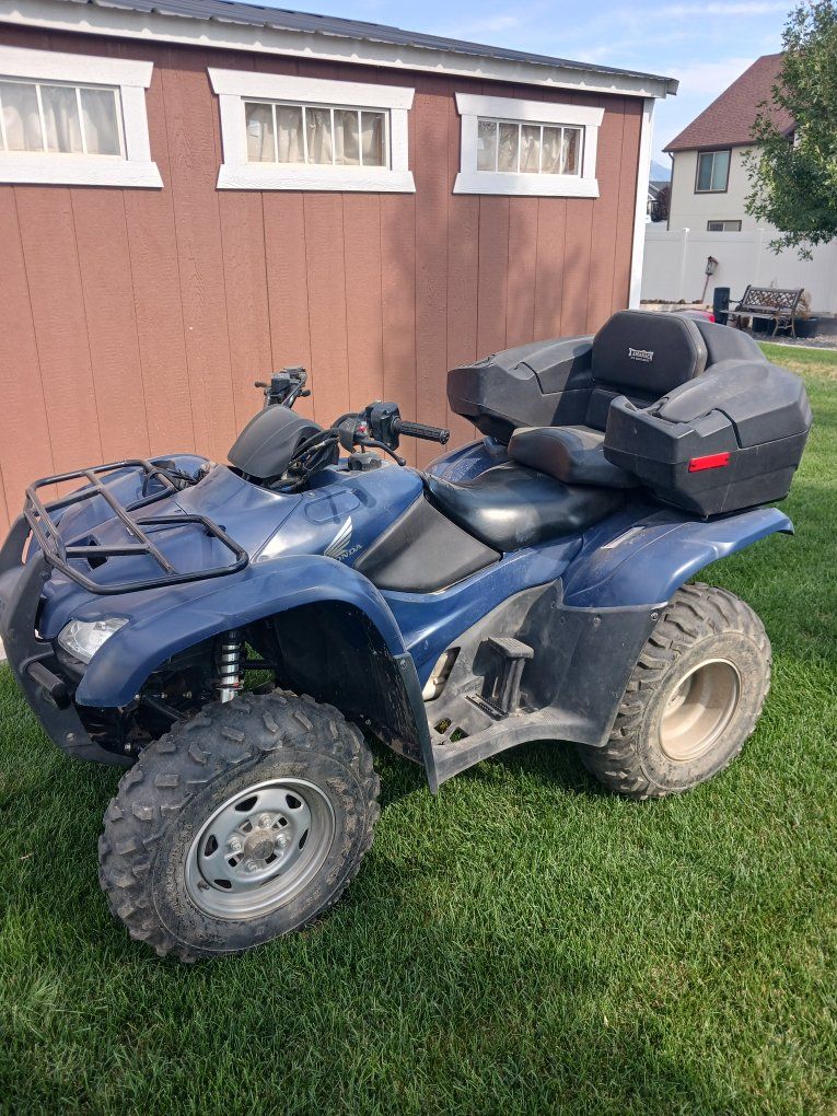 Two Honda Rancher ES ATVs and Echo Trailer for transporting.