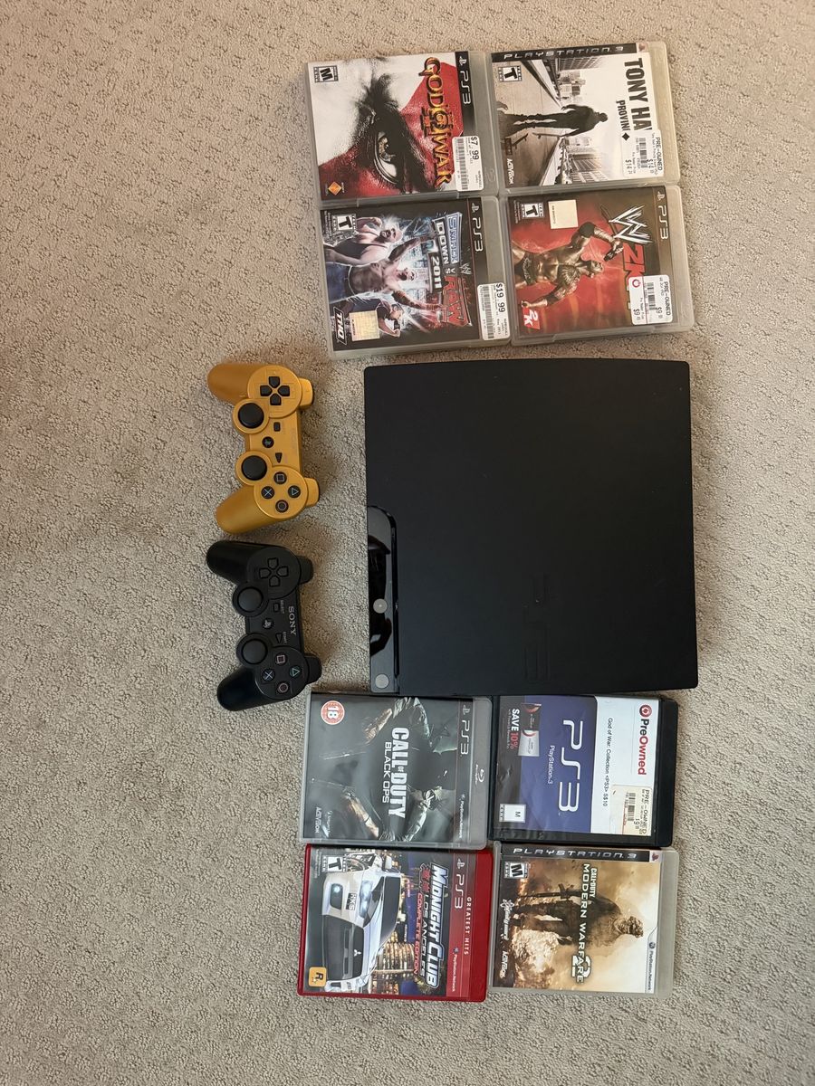PlayStation 3 PS3 Slim with 2 controllers and 8 Games