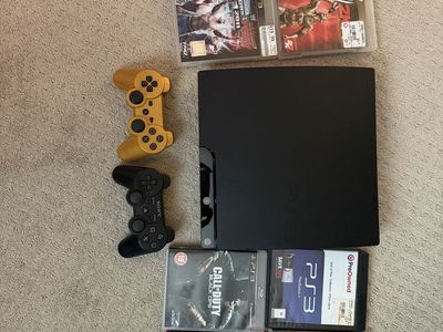 PlayStation 3 PS3 Slim with 2 controllers and 8 Games