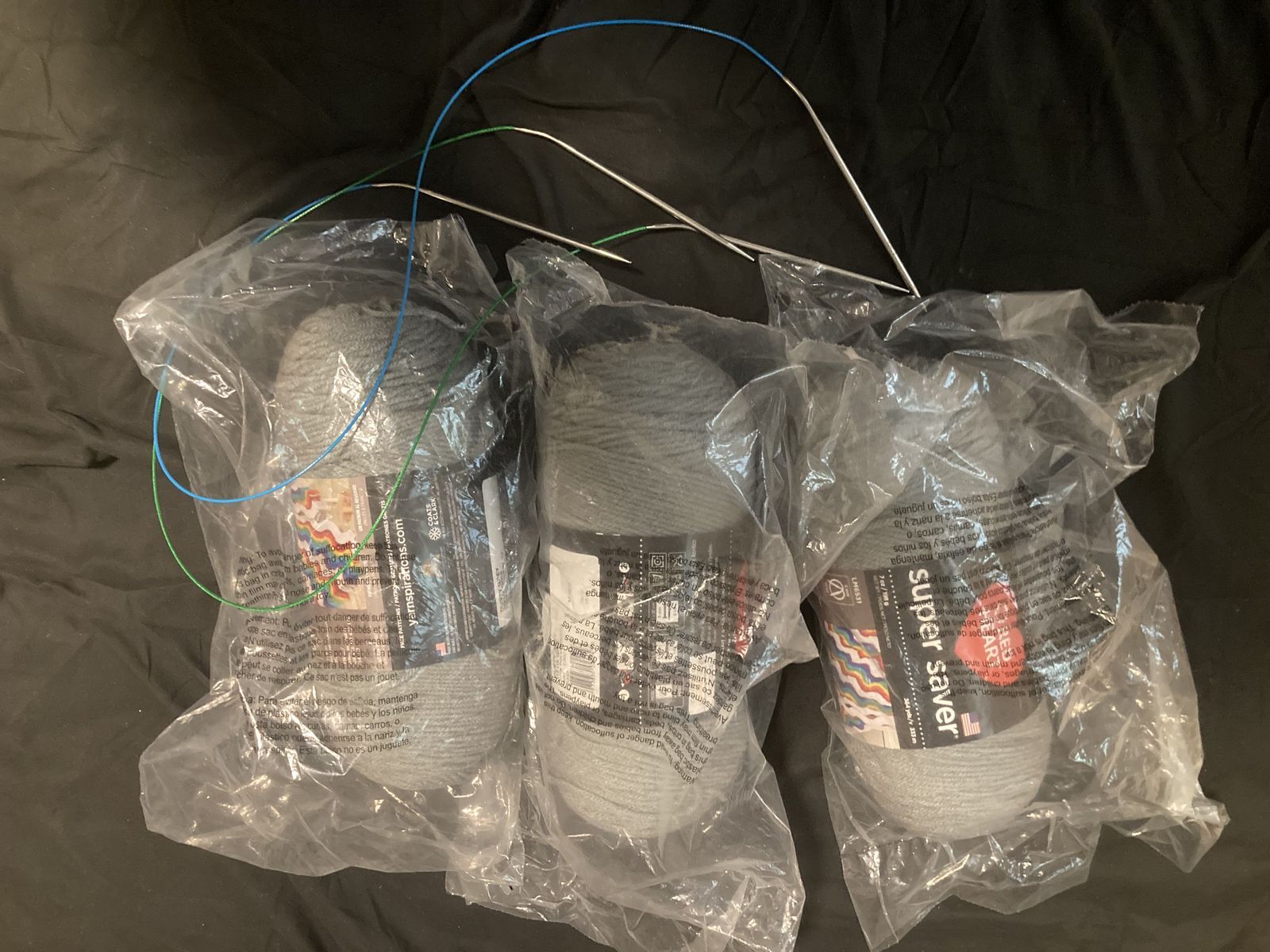 grey yarn and knitting needles