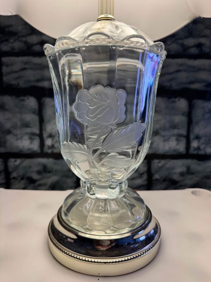 Glass or crystal lamp with two embossed roses and white shade.