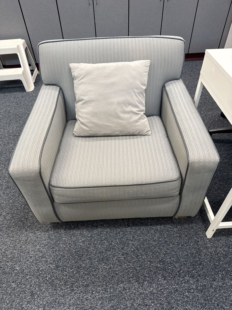 Light Gray Patterned Upholstered Armchair with Piping Accent and Throw Pillow