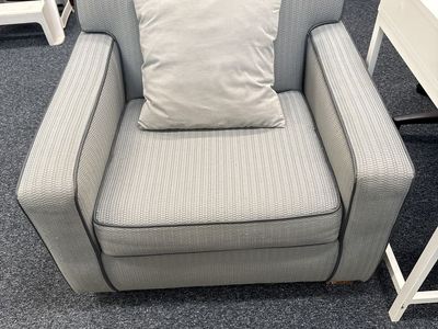 Light Gray Patterned Upholstered Armchair with Piping Accent and Throw Pillow