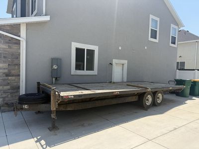 Heavy-Duty Dual-Axle Flatbed Utility Trailer with Spare Tire