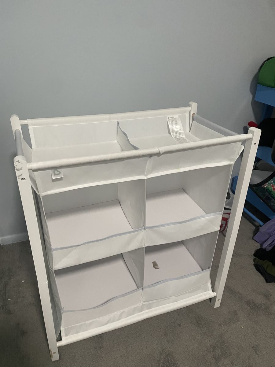 Baby holding dresser