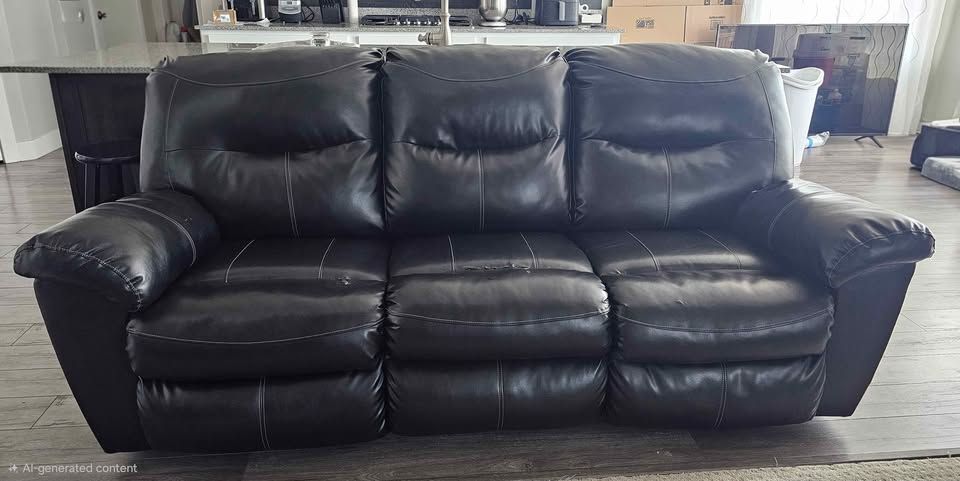 Black Faux Leather Reclining Sofa.  Well loved and comfortable.  Just a little worn.