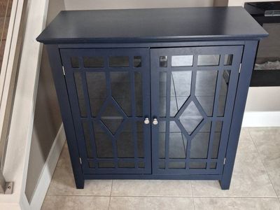 Decorative blue, glass door end table. Two available.