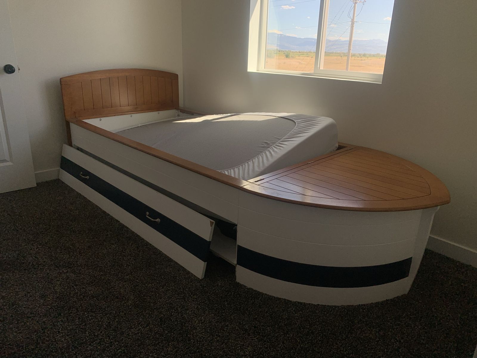 Nautical Boat Shaped Twin Bed with Built-in Storage and pull out bed. Two new twin mattresses included. 
