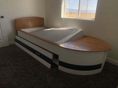 Nautical Boat Shaped Twin Bed with Built-in Storage and pull out bed. Two new twin mattresses included.