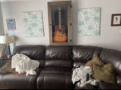 Genuine leather sofa with 2 electric recliners and 1 manual recliner. There are also 2 cupholder and storage sections available.