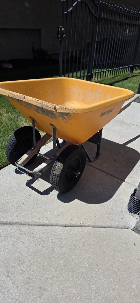 Used Orange Poly Wheelbarrow with Dual Wheels