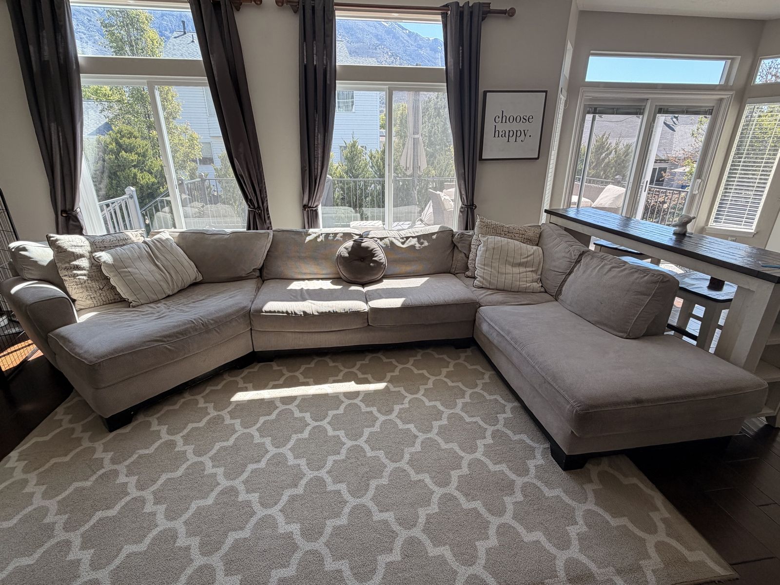 Large beige sectional couch with chaise