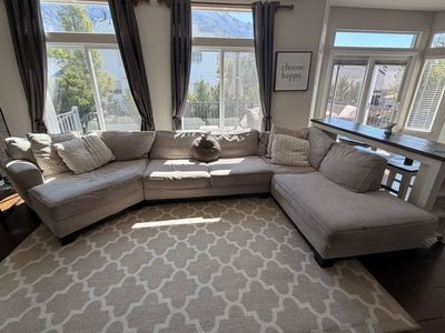 Large beige sectional couch with chaise