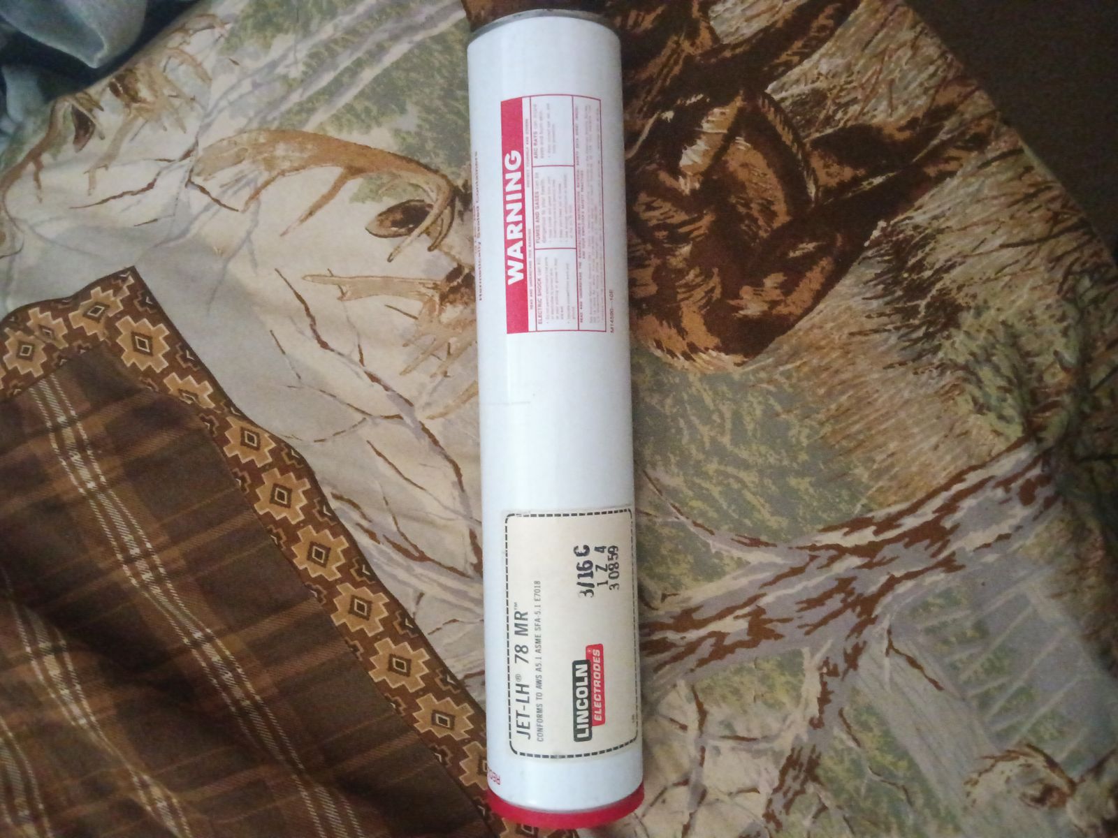 10 lb cans of sealed welding rod.