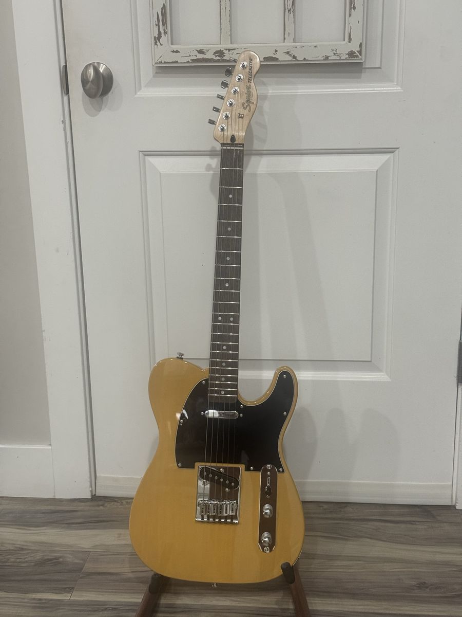 Squier by Fender Telecaster Electric Guitar - Butterscotch Blonde with black pick guard. New condition set up and sounds great. 
