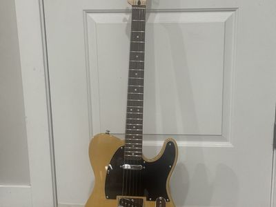 Squier by Fender Telecaster Electric Guitar - Butterscotch Blonde with black pick guard. New condition set up and sounds great.