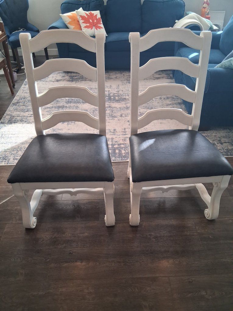 Two, white solid wood chairs