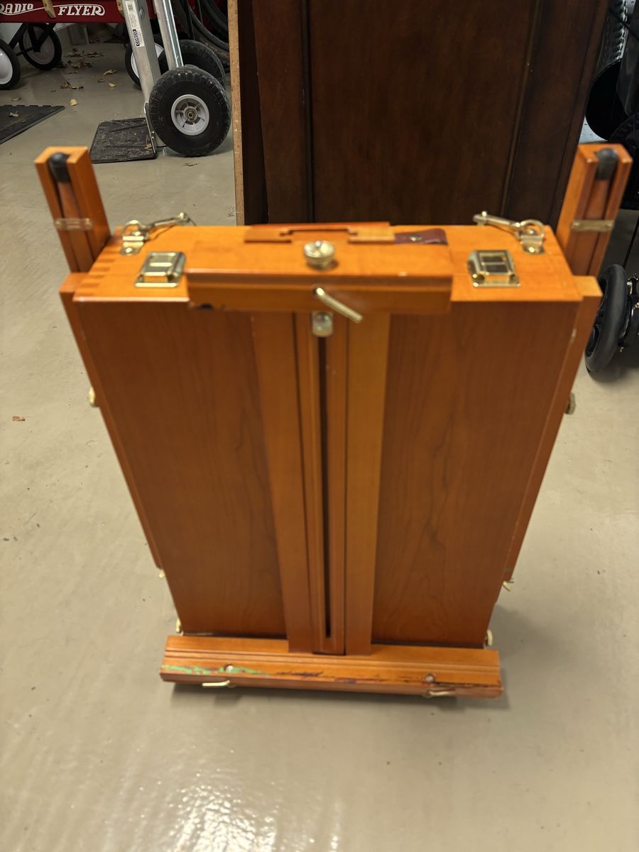Wooden easel with paint supplies