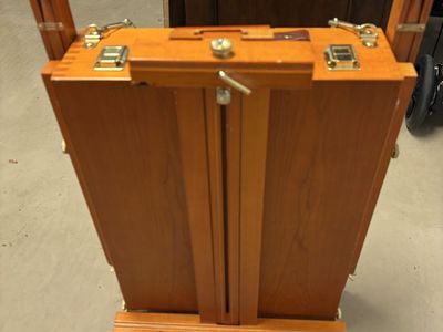 Wooden easel with paint supplies