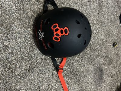Triple Eight Skate Helmet Matte Black with Red Inner Lining and spitfire sticker