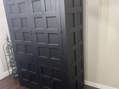 Large Black Wooden Armoire Cabinet with Panel Details and Storage