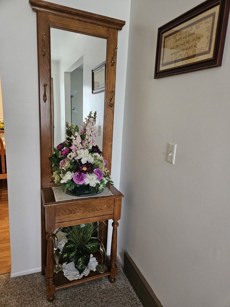 Entry mirror/coat hanger.