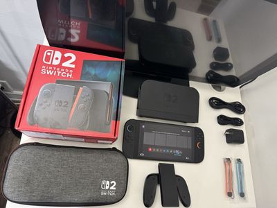 Nintendo Switch 2 / Dock / Joy Cons / Grip /Power Cable / Hdmi Cable / Carrying Case / Box