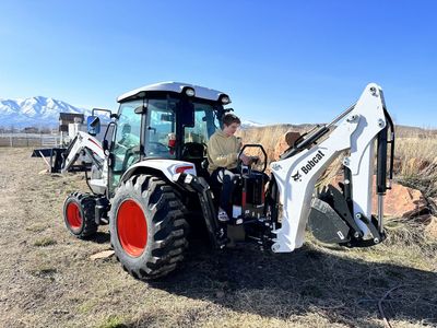 2023 Bobcat CT5555 enclosed A/C Radio with backhoe, 72" mowing deck, front loader and front hay forks