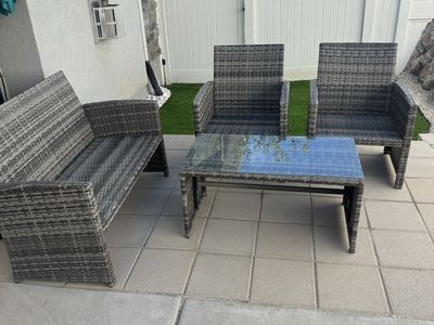 Durable Grey Wicker 4-Piece Patio Set: Loveseat, 2 Armchairs, Coffee Table with Tempered Glass