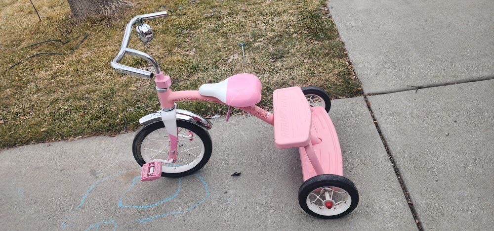 Pink Radio Flyer trike with bell solid wheels