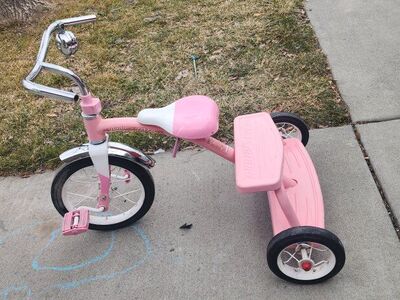 Pink Radio Flyer trike with bell solid wheels