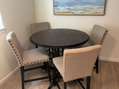 Bar Height Dining Table (45" Dia) & 4 Nailhead Studded Beige Tufted Chairs, Dark Wood/Metal