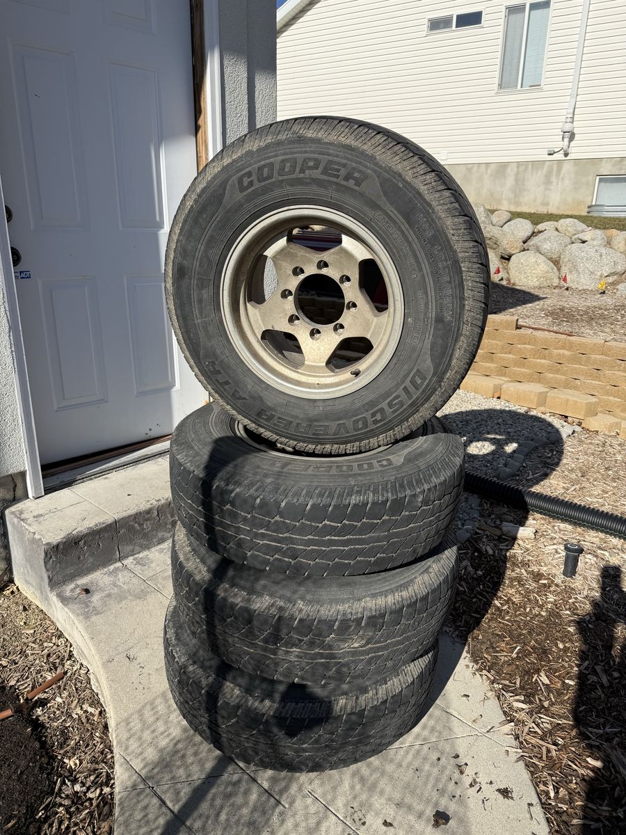 Set of 4 Cooper Discoverer AT3 265/75R16 Tires with Wheels - 8x6.5” (8x165.1mm)