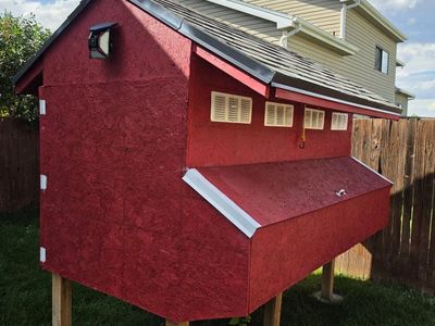 Custom Built Wooden Chicken Coop in Red with Shingled Roof and Elevated Design
